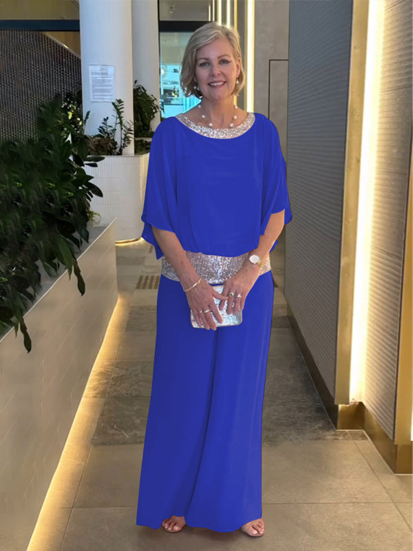 Woman wearing a wide-leg trouser and flowy blouse set, a lightweight and elegant all-season outfit.