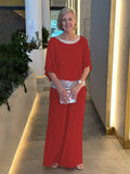 Woman wearing a 2-piece wide trousers & airy blouse set, lightweight and elegant all-season outfit.