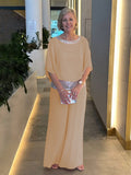 Woman wearing a 2-piece wide-leg trousers and blouse set, lightweight and elegant all-season outfit.