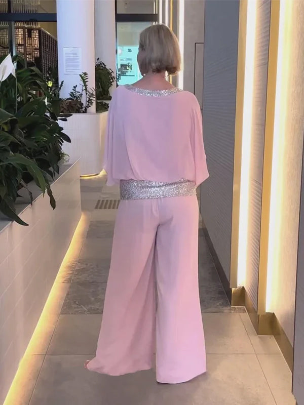 Woman wearing the 2-piece wide trousers & airy blouse set; lightweight, elegant, all-season outfit.