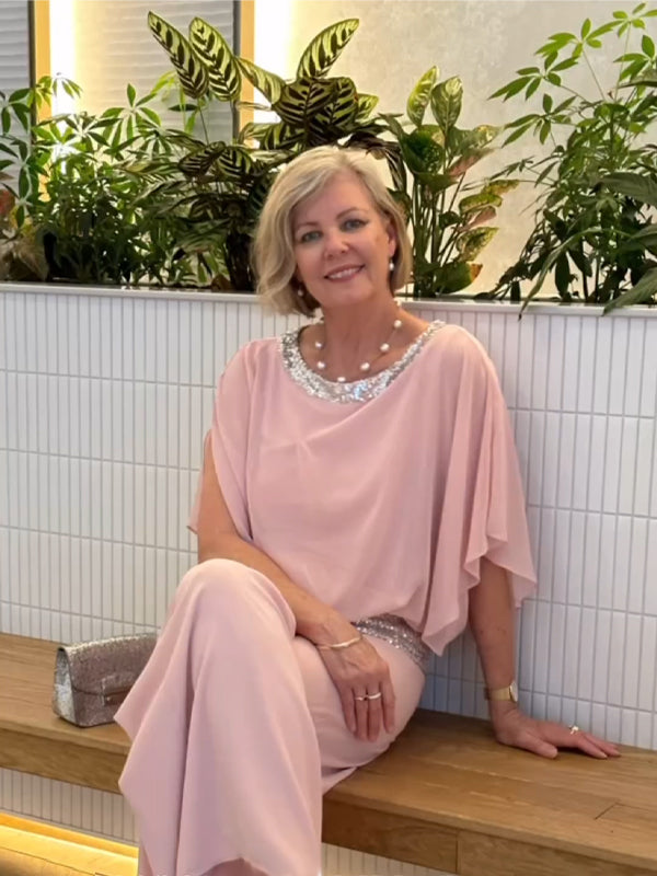 Woman wearing a lightweight, elegant 2-piece wide-leg trousers and blouse set.