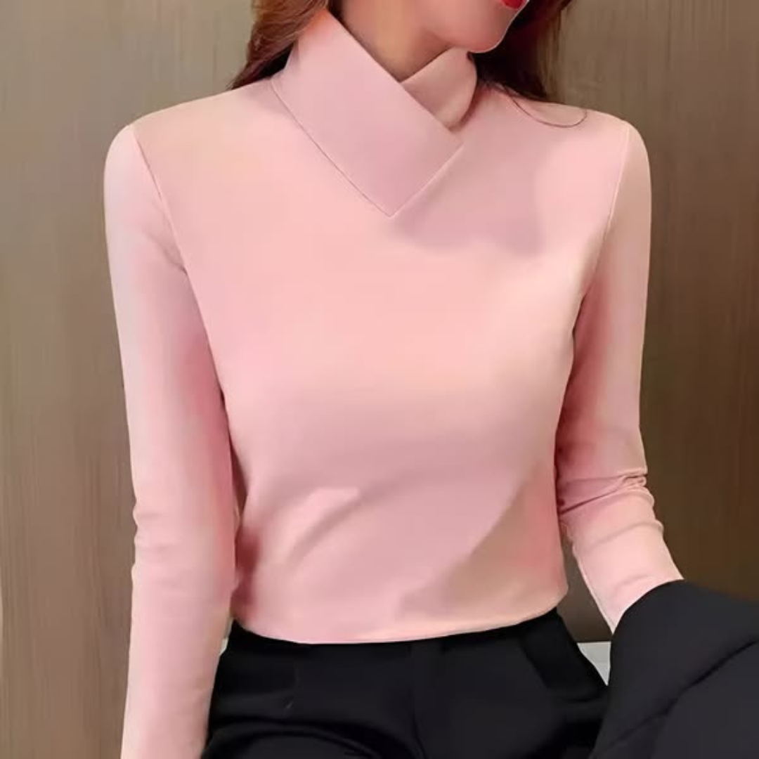 Woman wearing an asymmetric turtleneck office shirt, a stylish and modern work top.