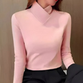 Woman wearing an asymmetric turtleneck office shirt, a stylish and modern work top.