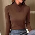 Woman in asymmetric turtleneck office shirt, a stylish and modern work outfit.