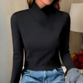 Woman wearing an asymmetric turtleneck office shirt, a stylish and modern top for professional women.