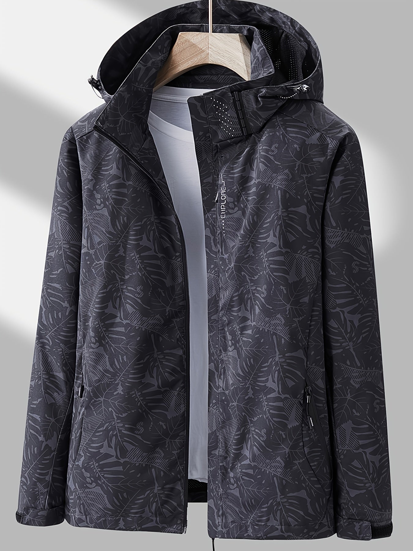Camouflage outdoor jacket for women: Waterproof, removable hood, relaxed fit.