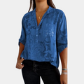 Woman wearing a purple adjustable long sleeve blouse, a versatile and elegant all-season top.