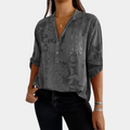 Woman wearing a purple adjustable long sleeve blouse, an elegant and versatile all-season top.