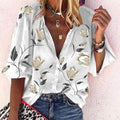Woman wearing a 3D floral print long-sleeved top.