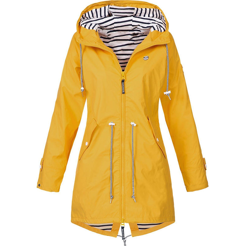 Woman wearing the all-season waterproof rain jacket in an outdoor setting, showcasing its lightweight design and fit.