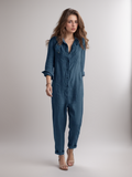 Button-down long sleeve jumpsuit for women in a relaxed fit with utility pockets and a soft cotton blend.