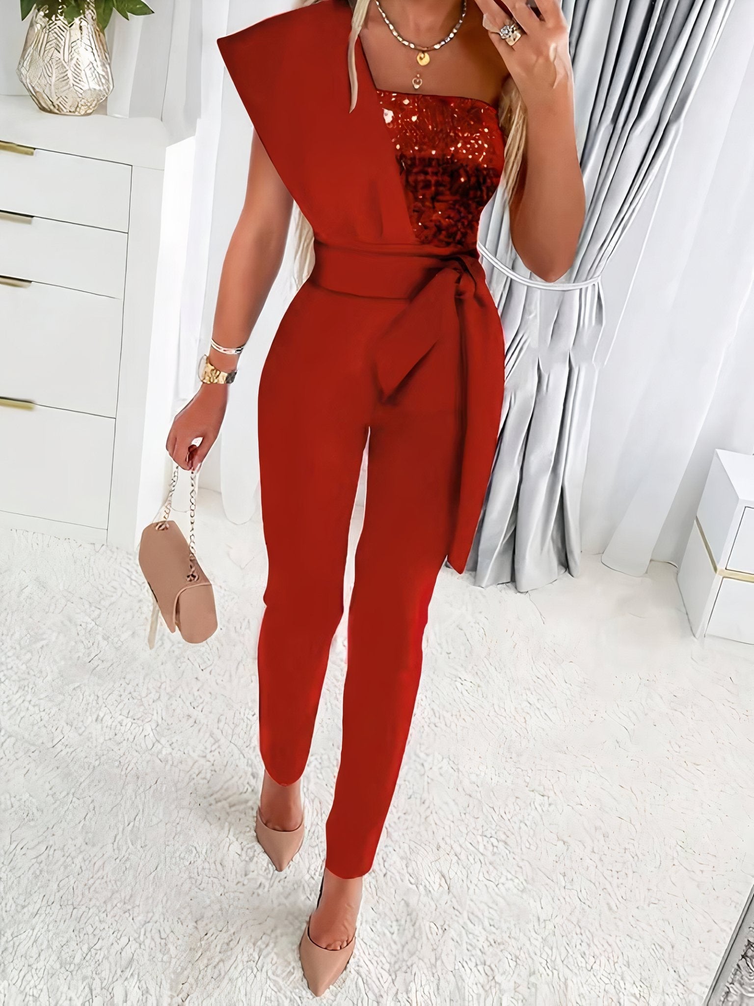Bodycon sequin jumpsuit for women, sleeveless, full-length, shimmering and form-fitting design.