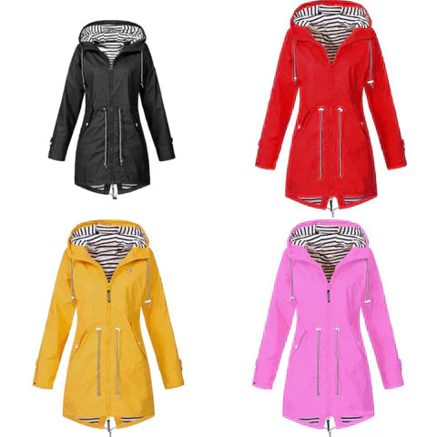 Woman wearing a stylish all-season waterproof rain jacket hiking outdoors in misty weather.