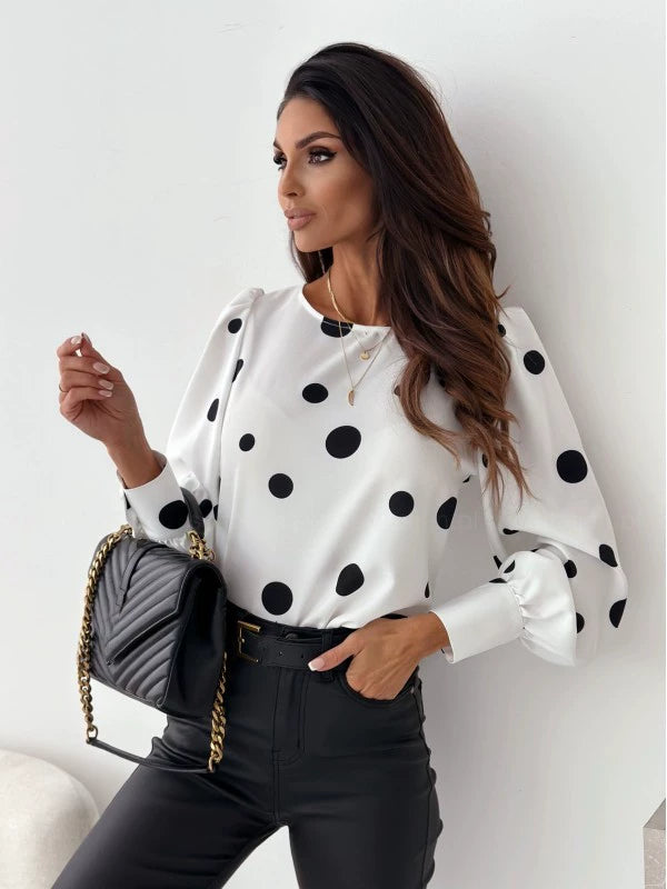 Woman wearing a breathable polka dot blouse; light fabric, regular fit.