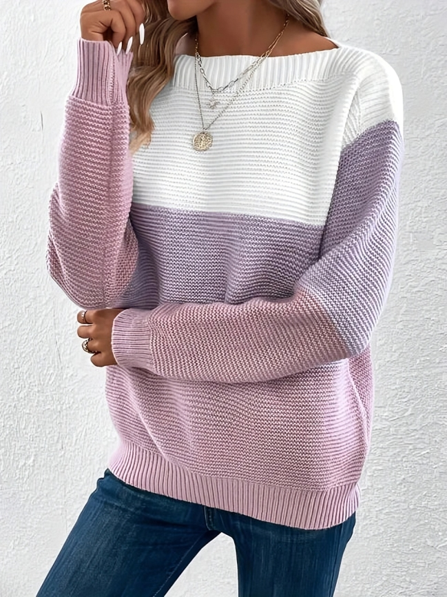 Woman wearing a khaki boat neck long sleeve knit sweater.