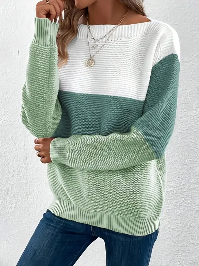 Woman wearing a boat neck long sleeve knit sweater in khaki.