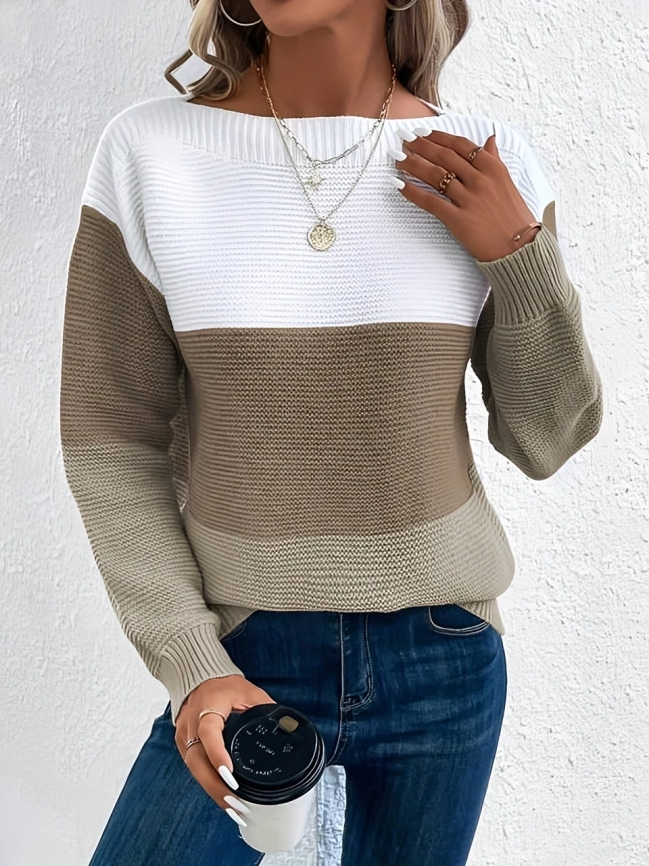 Woman wearing a boat neck long sleeve knit sweater in a relaxed fit.