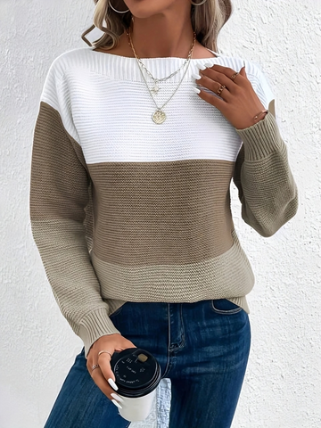 Woman wearing a boat neck long sleeve knit sweater in a relaxed fit.