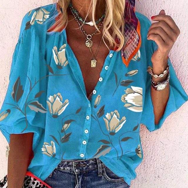 Woman wearing a 3D floral print long-sleeved top, showcasing its vibrant design and relaxed fit.