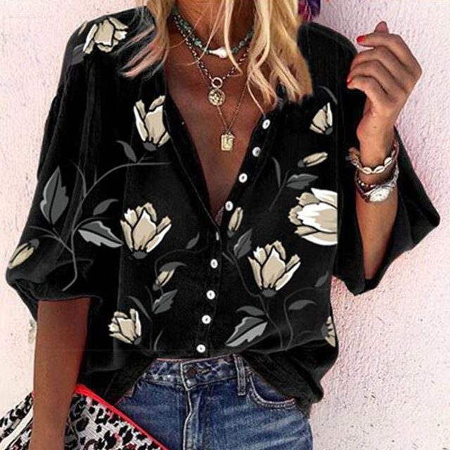 Woman wearing a 3D floral print long-sleeved top.
