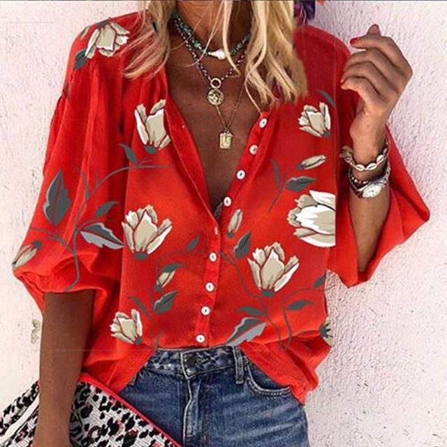 Woman wearing 3D floral print long-sleeved top, showcasing the vibrant pattern and loose fit.