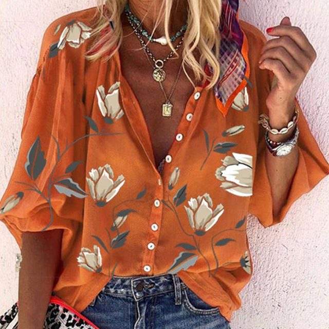 Woman wearing a 3D floral print long-sleeved top, showcasing its vibrant design and relaxed fit.