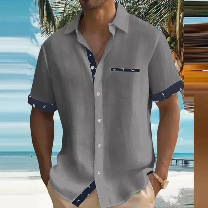 Man wearing an adorable summer casual shirt with a bird print and button-down design.